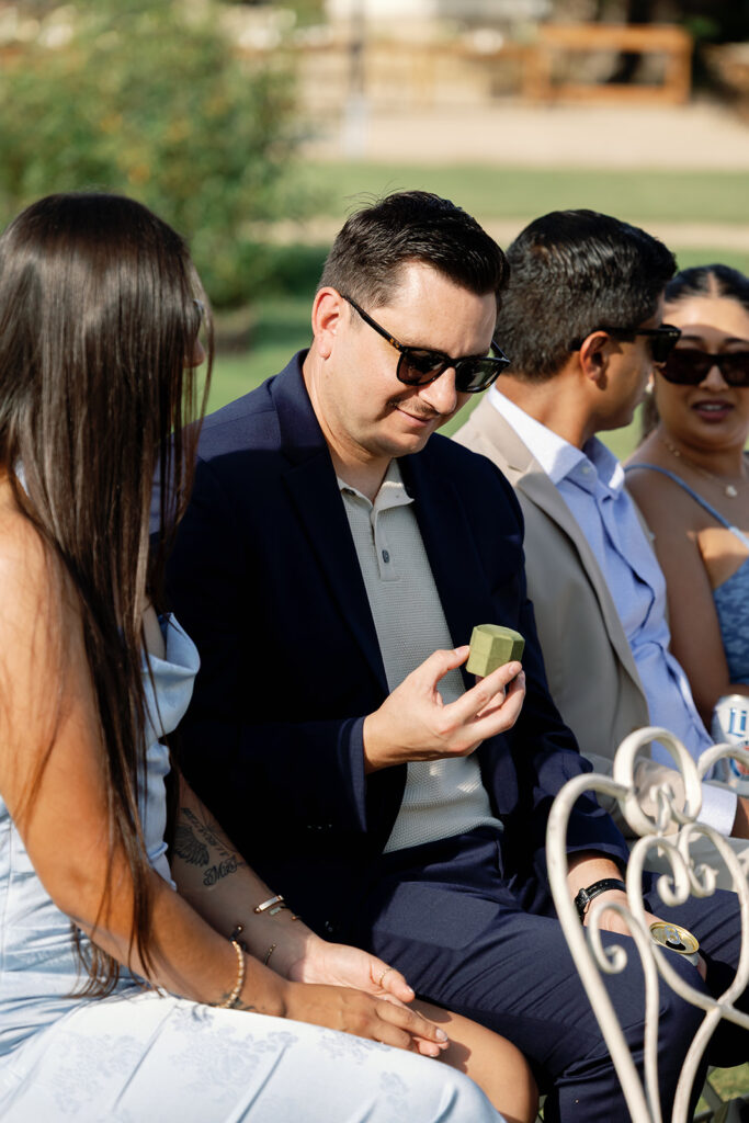 Guest holding ring box during ceremony at Swanner House wedding.