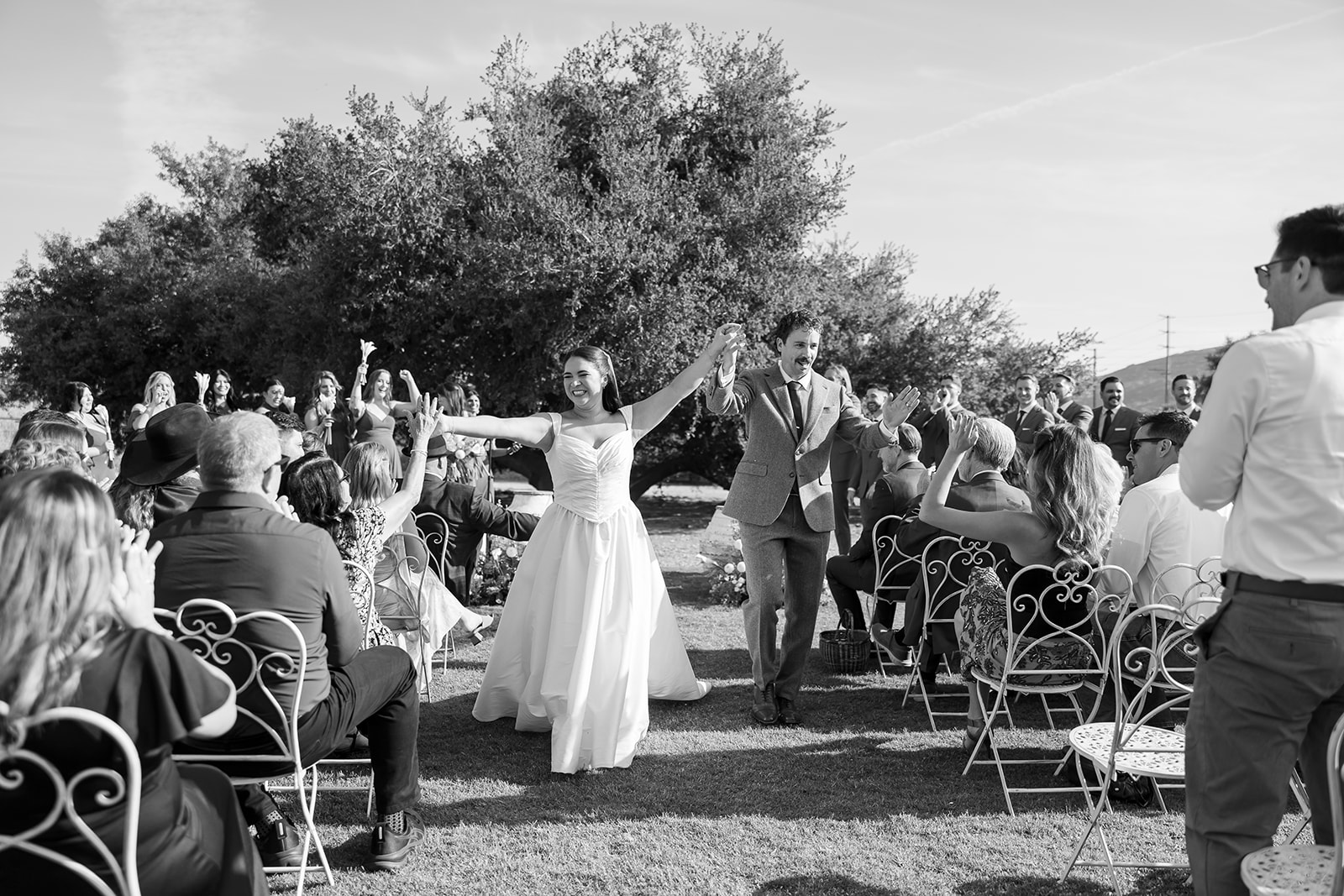 Bride and groom walking down aisle after ceremony at Swanner House wedding in San Juan Capistrano.