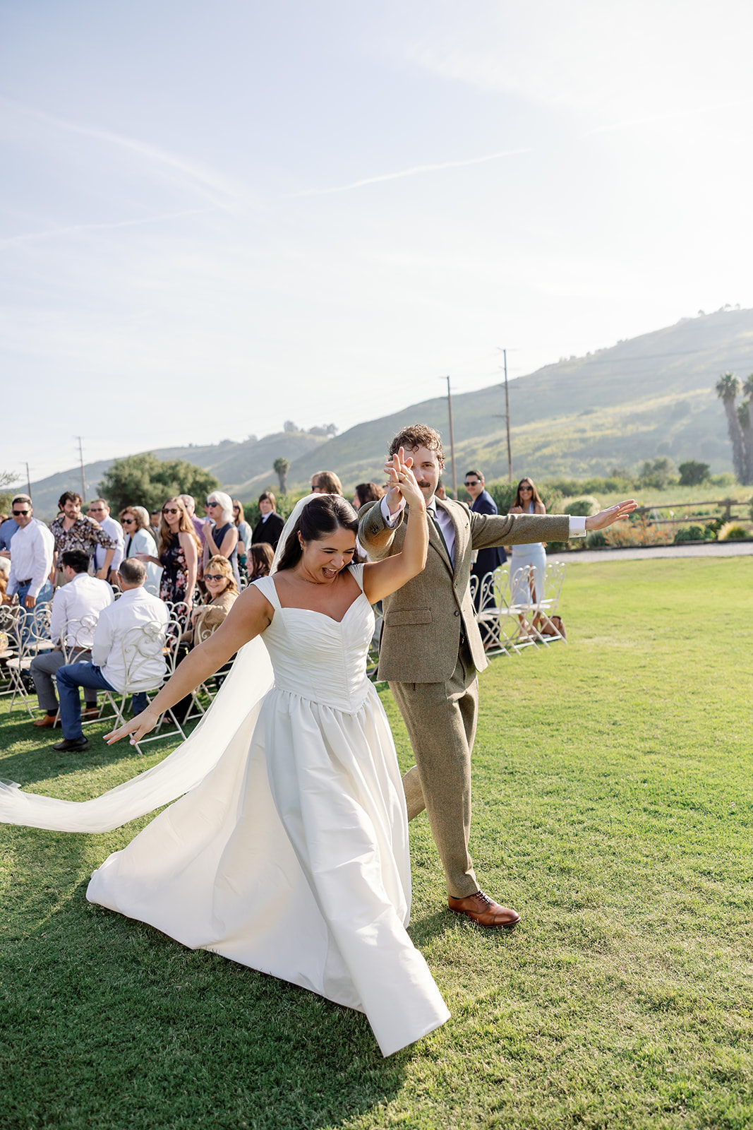 Bride and groom walking down aisle after ceremony at Swanner House wedding in San Juan Capistrano.
