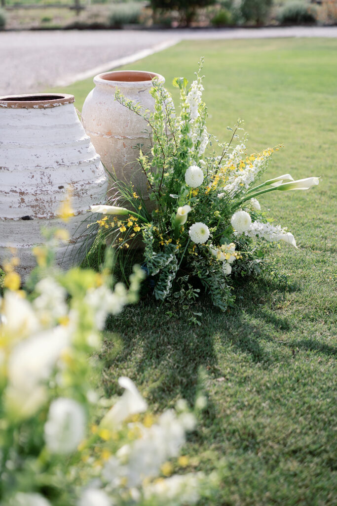 Ceremony floral arrangement with white and yellow flowers at Swanner House wedding in San Juan Capistrano.