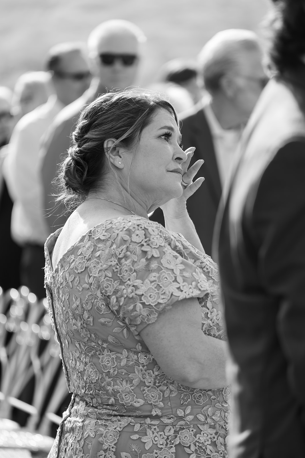 Guest wiping away tears during ceremony at Swanner House wedding in San Juan Capistrano.