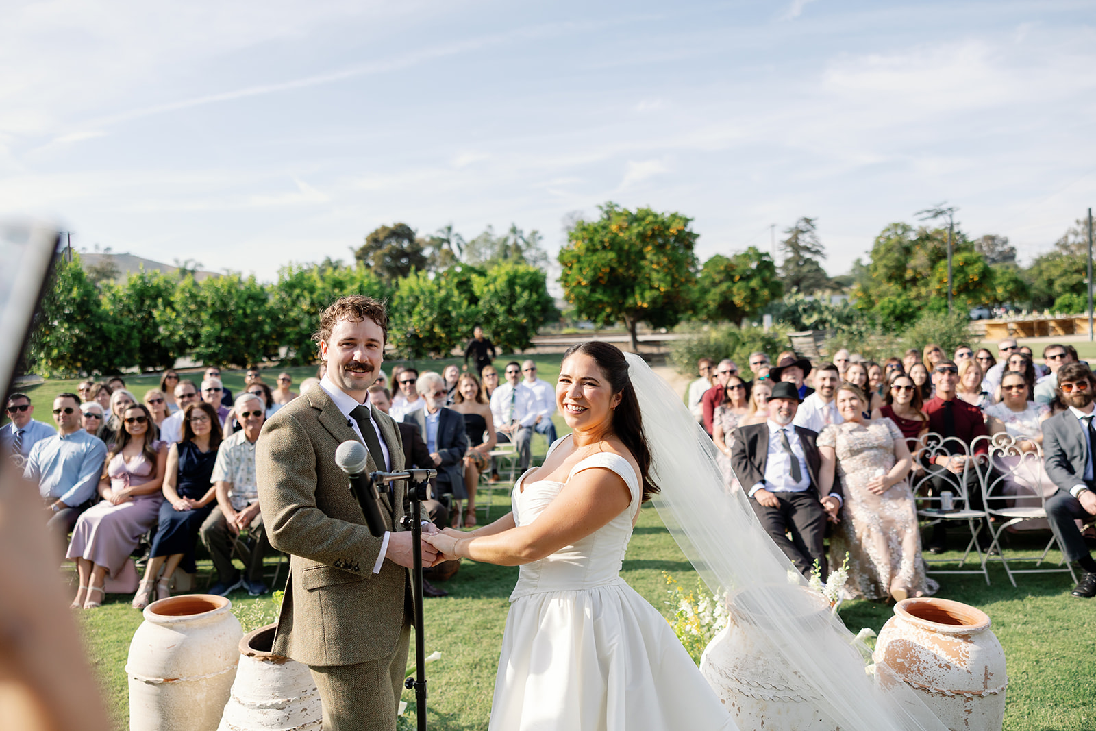 Bride and groom at altar with guests seated behind them at Swanner House wedding.