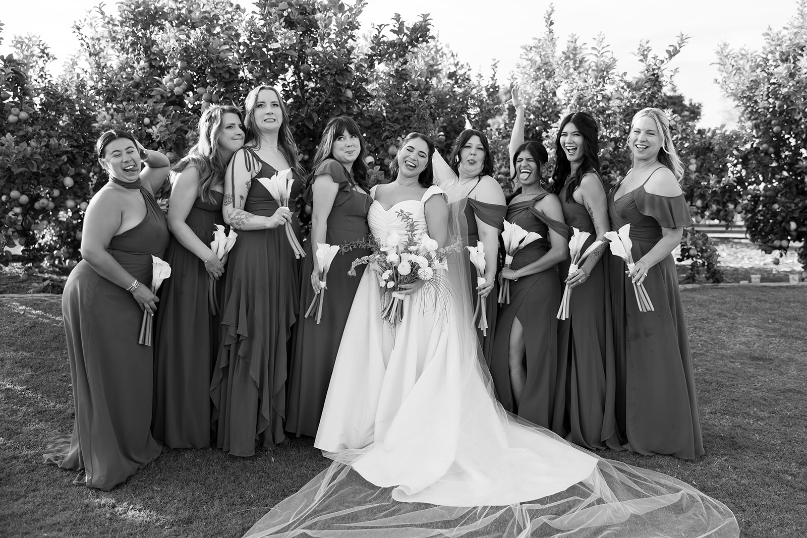 Bride with bridesmaids posing together at Swanner House wedding in San Juan Capistrano.