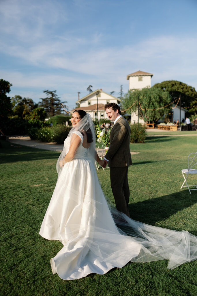 Bride and groom posing on the lawn at The Swanner House.