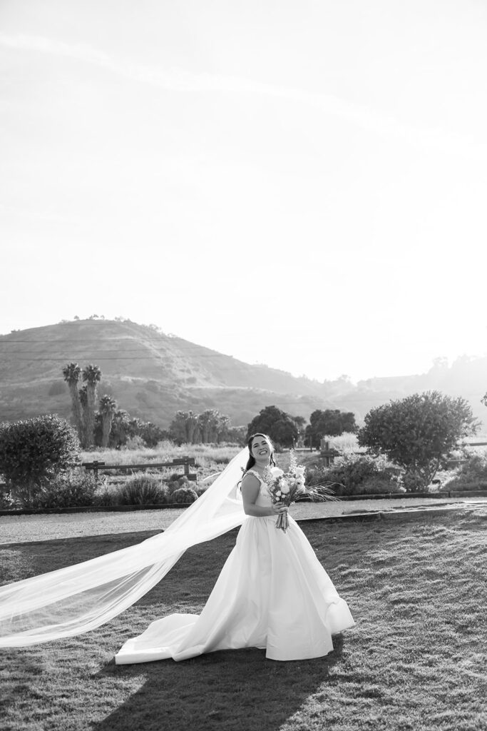 Black and white portrait of a bride posing on the lawn at The Swanner House.