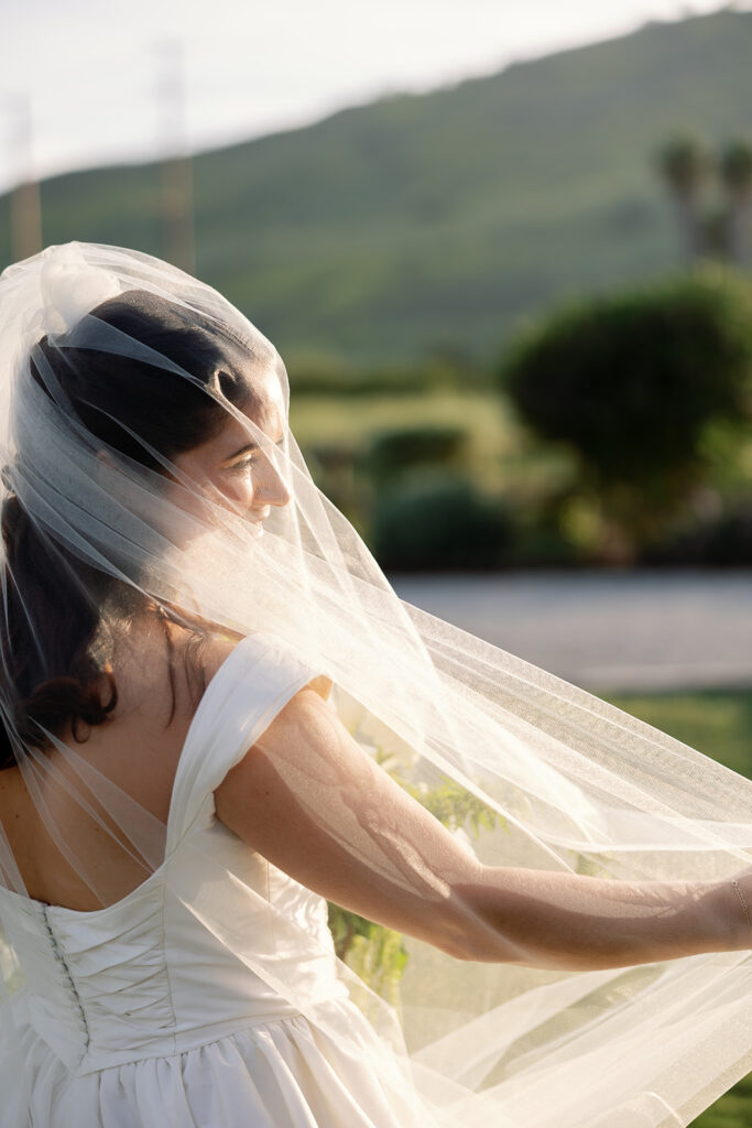 Under veil portrait of a bride during golden hour at Swanner House in San Juan Capistrano.