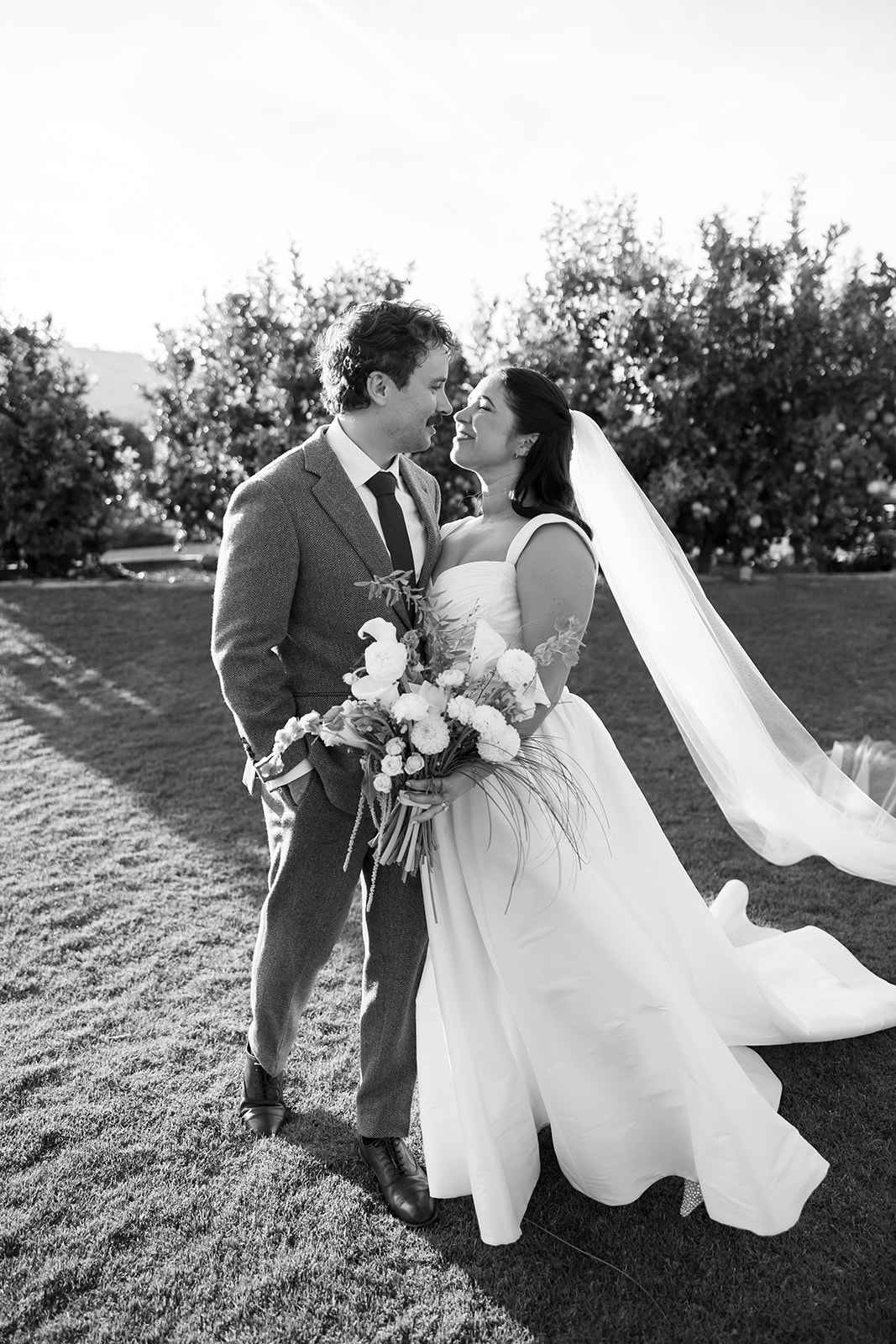 Bride and groom smiling together during portraits at Swanner House wedding in San Juan Capistrano.