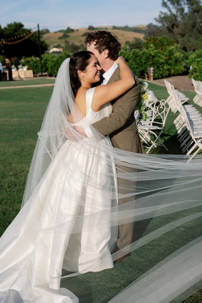 Bride and groom hugging during their portraits outside at The Swanner House.