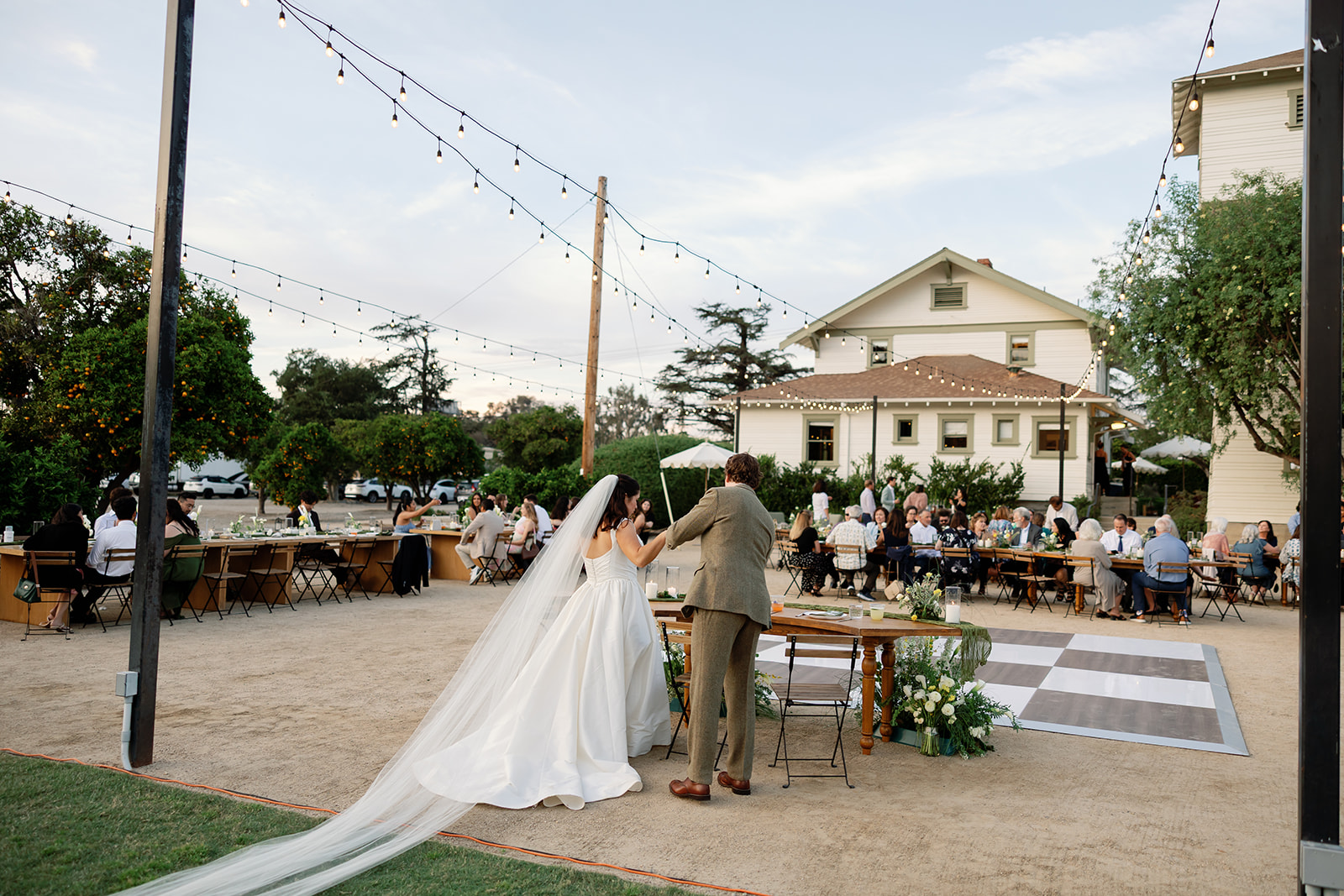 Bride and groom getting ready to sit at their sweethearts table.