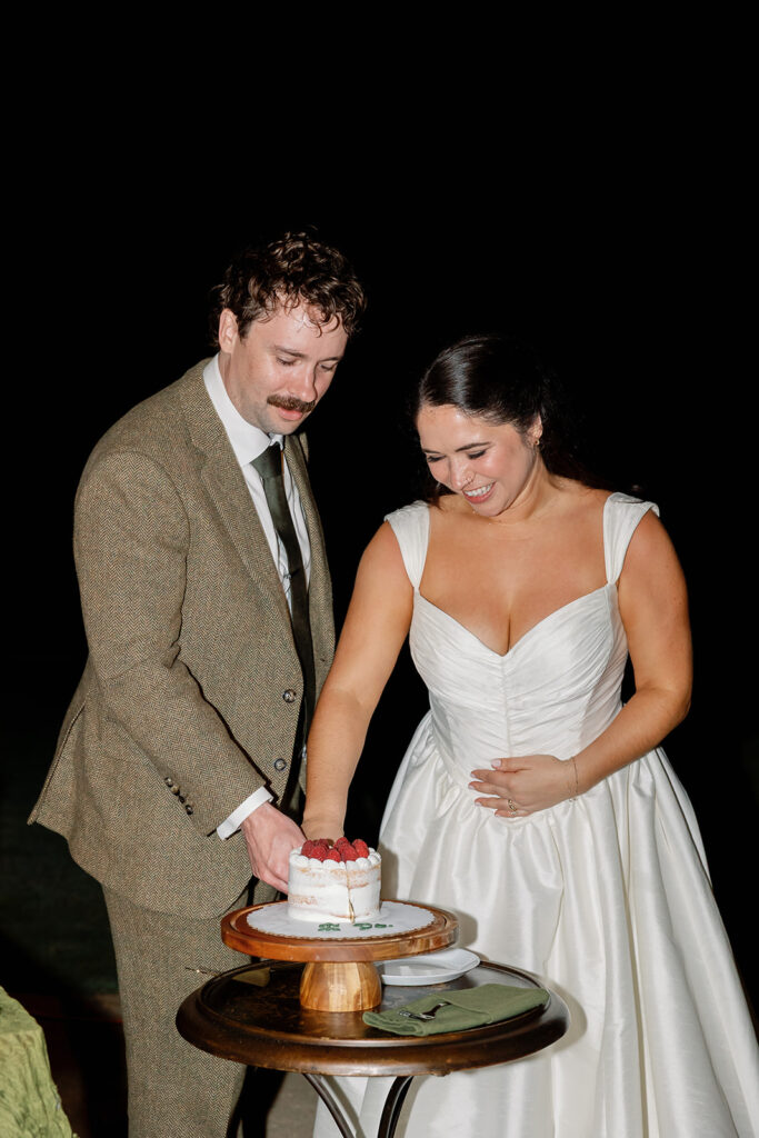 Bride and groom cutting into their personal sized wedding cake.