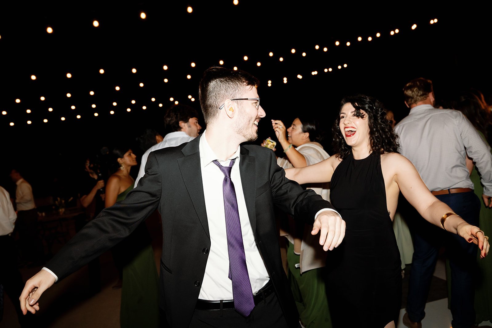 Guests dancing during a fun Swanner House wedding reception in San Juan Capistrano.