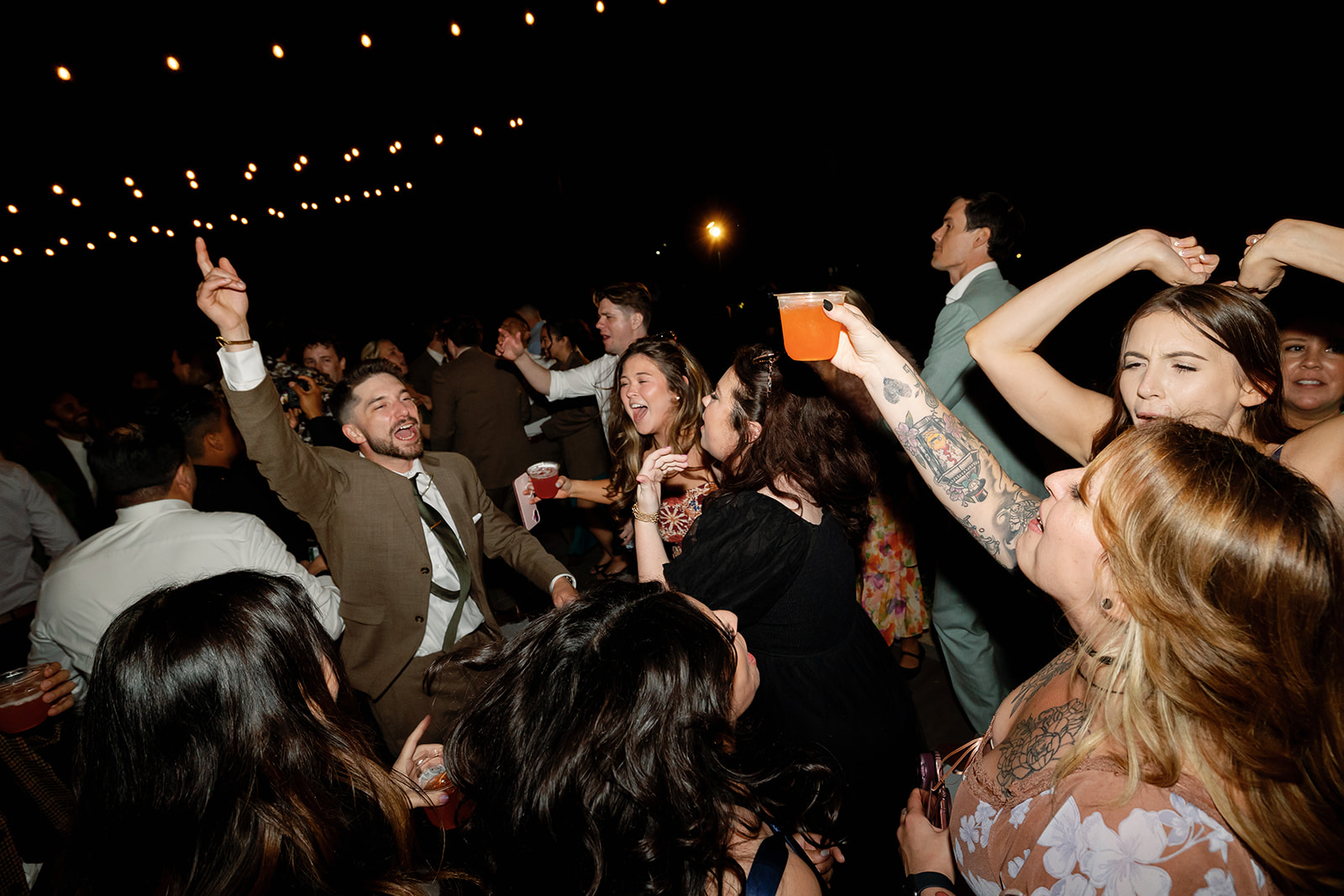 Guests dancing during a fun Swanner House wedding reception in San Juan Capistrano.