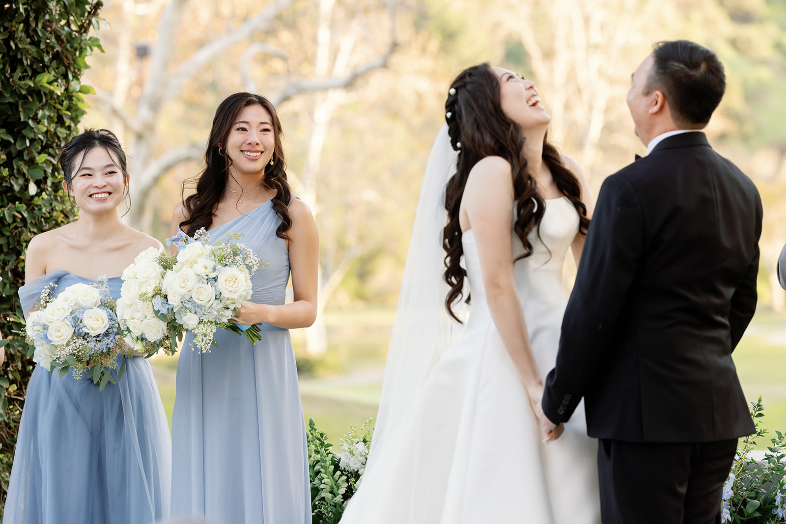 Candi photo of the bride laughing during her Coyote Hills Golf Club wedding ceremony.