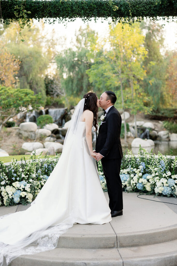 Bride and groom kissing during their ceremony.