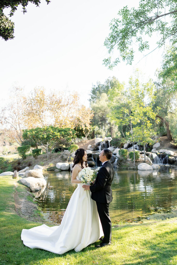 Bride and groom standing together after sharing a first look at Coyote Hills Golf Course.