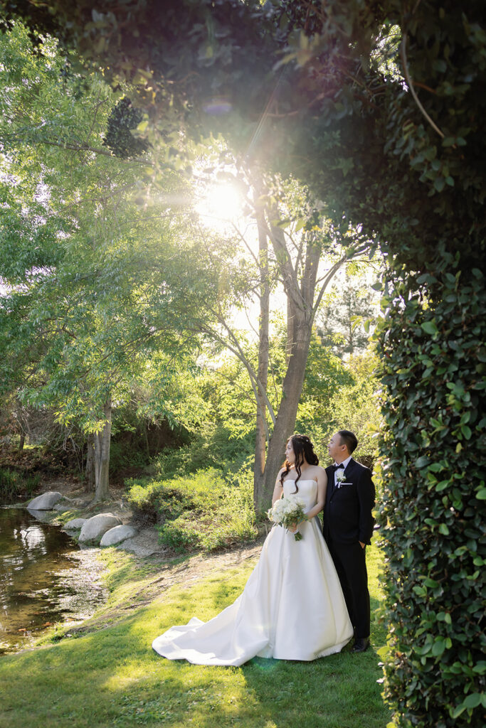 Bride and groom admiring the pond at Coyote Hills Golf Course.