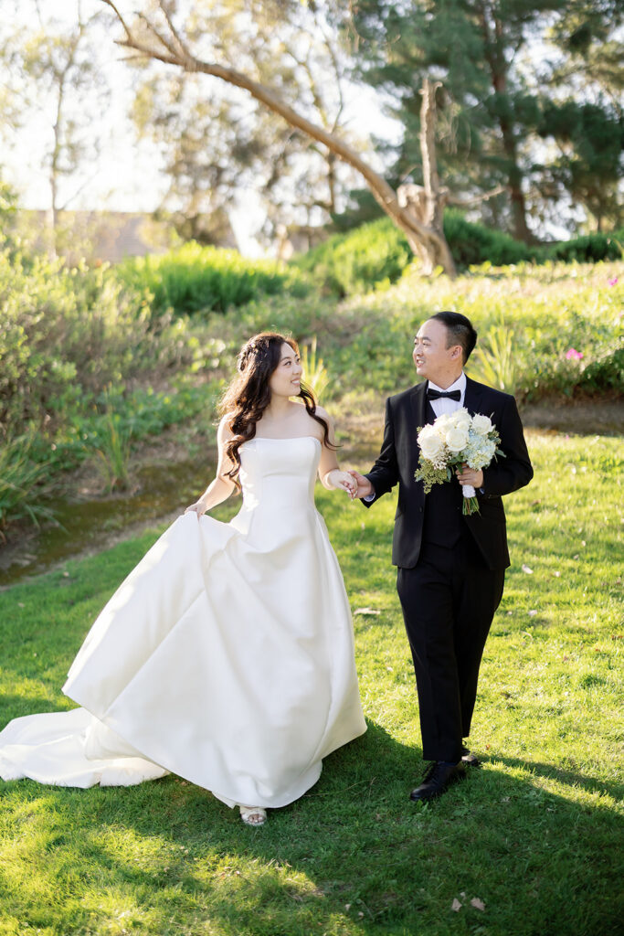 Bride and groom walking on the property at Coyote Hills Golf Course.