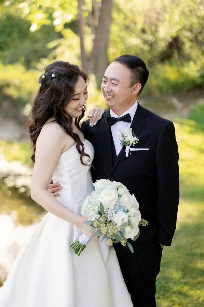 Groom smiling at the bride during their Coyote Hills Golf Course wedding photos.