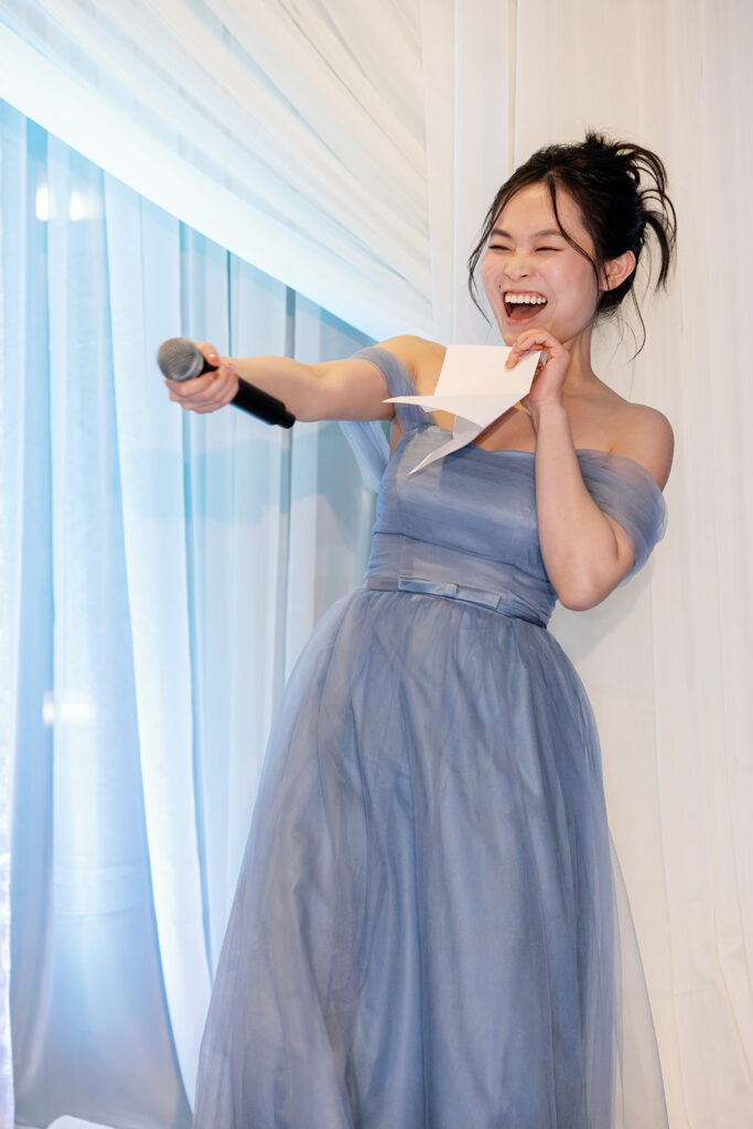 Bridesmaid laughing during giving a speech.