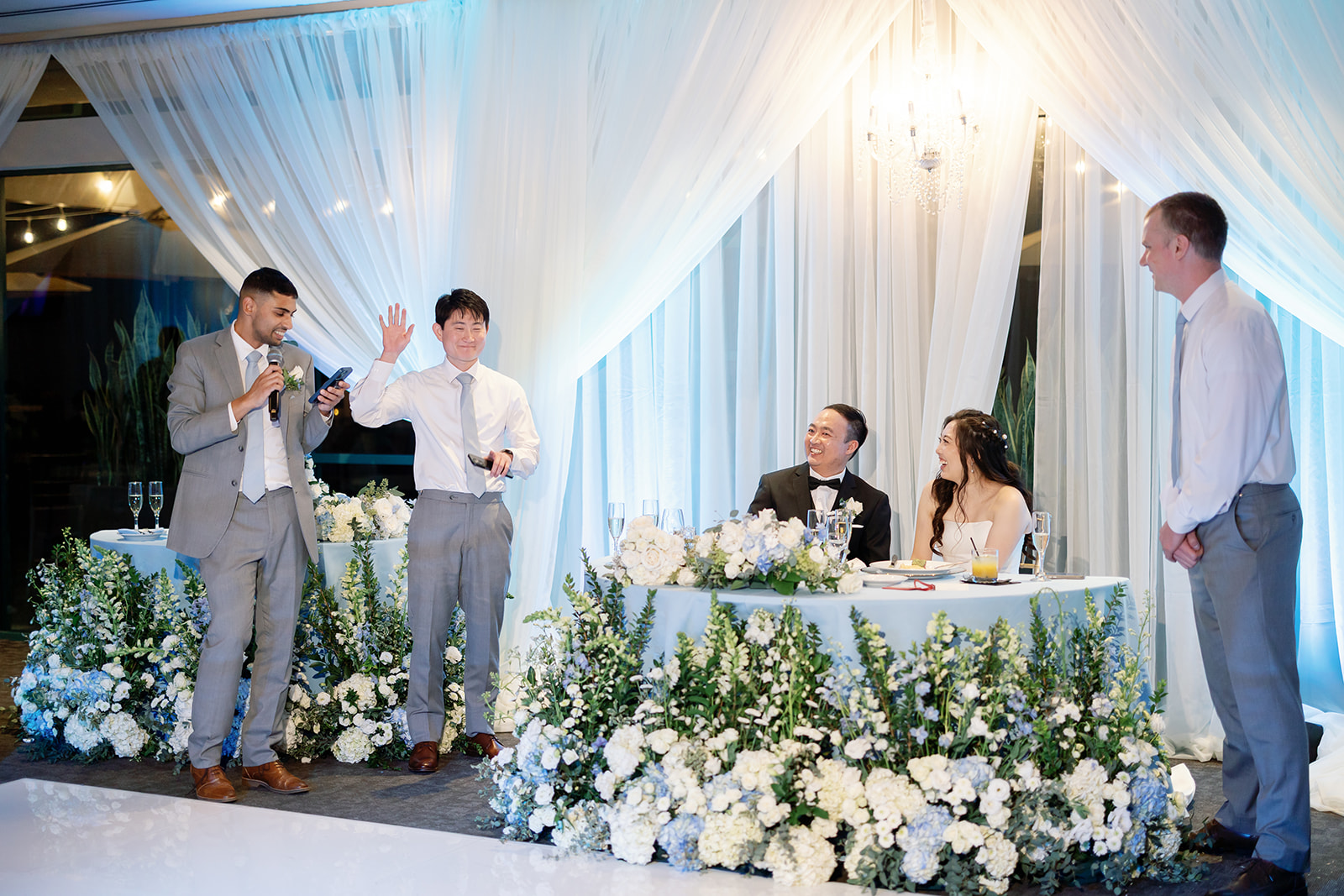 Guests giving a speech during an indoor Coyote Hills Golf Club wedding reception in the Vista Falls Pointe Ballroom.