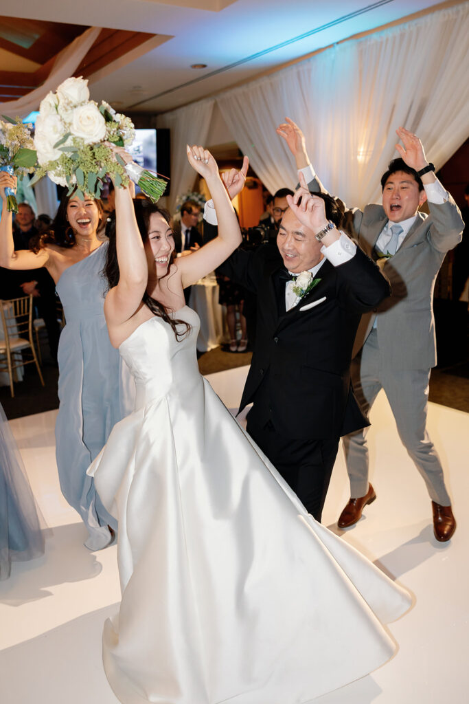 Bride and groom dancing with their wedding party for their Coyote Hills Golf Club wedding reception in the Vista Falls Pointe Ballroom.