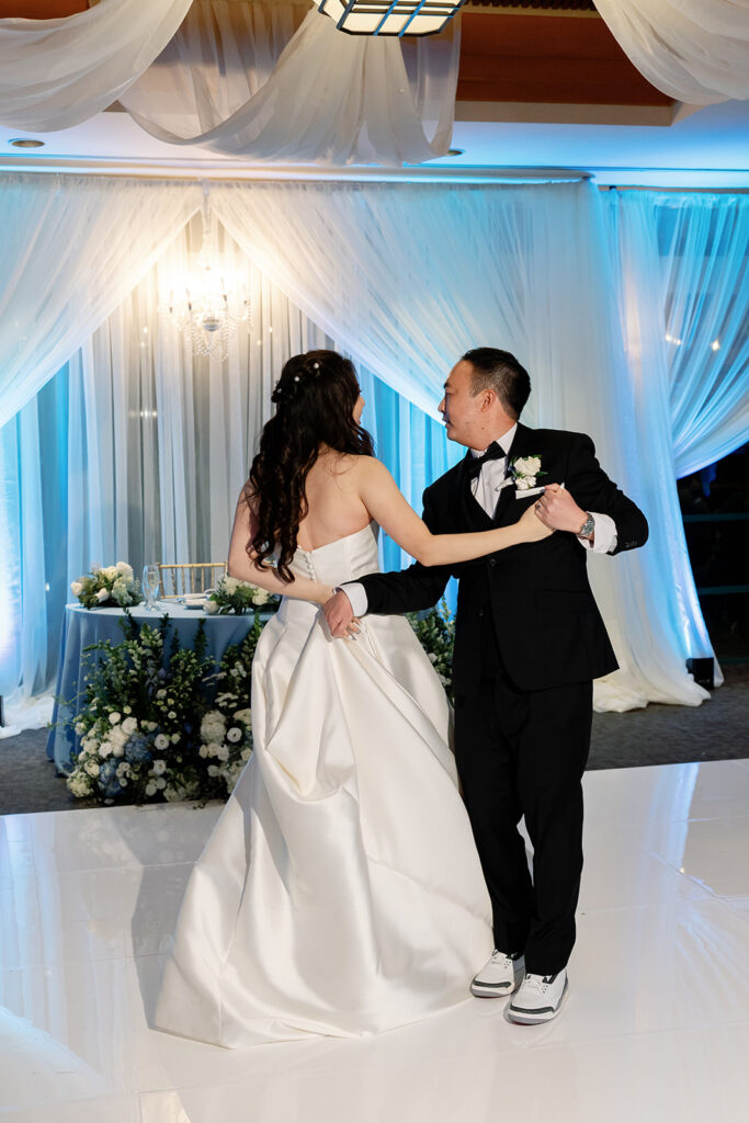 Bride and groom dancing for their first dance at Coyote Hills Golf Club wedding reception in the Vista Falls Pointe Ballroom.