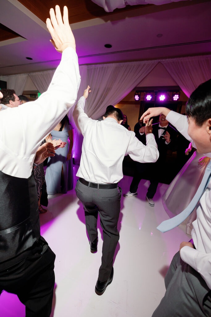 Guests dancing during a Coyote Hills Golf Club wedding reception in the Vista Falls Pointe Ballroom.