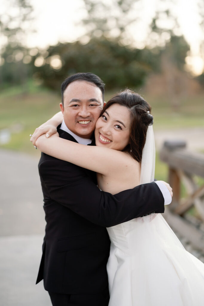 Close up shot of the bride and groom hugging during their golden hour portraits.