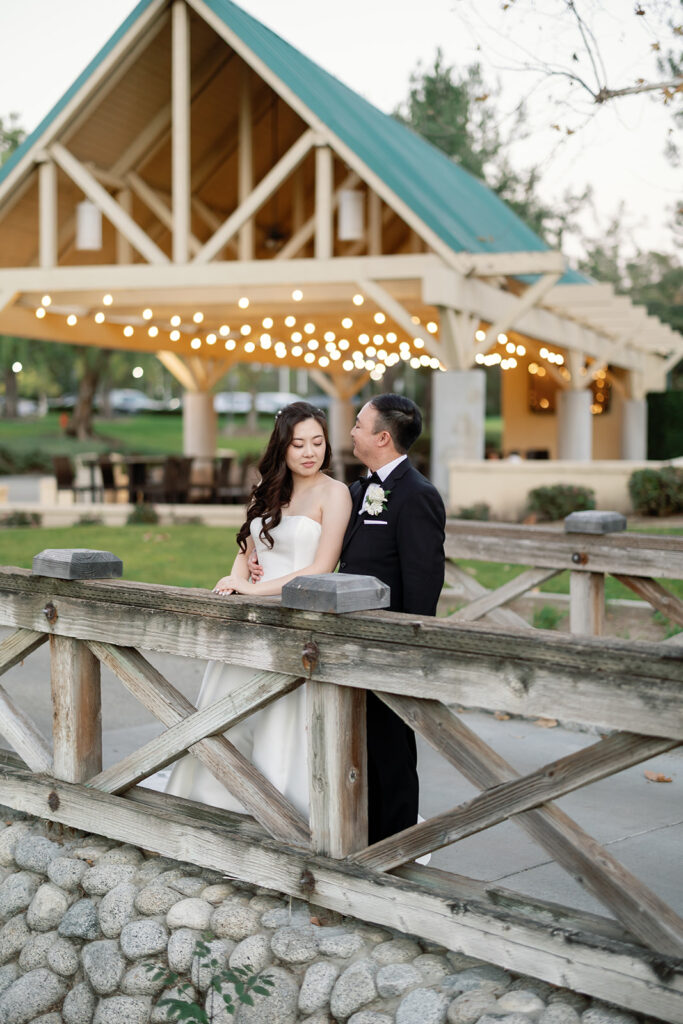 Bride and groom posing in front of The Payne Stewart Pavilion.
  