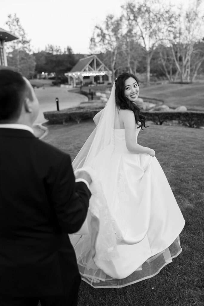 Black and white portrait of the bride and groom walking the property at Coyote Hills Golf Course.