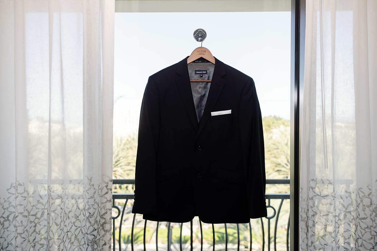 Grooms suit hanging from a window at the hotel.