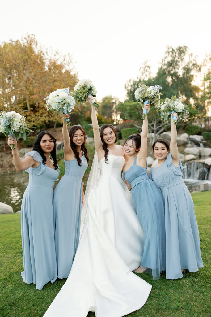 Bride and bridesmaids posing for a photo at Coyote Hills Golf Course.