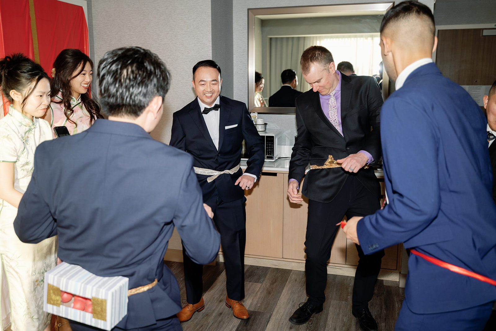Groom participating in fun wedding games before the tea ceremony at Marriott Los Angeles Monterey Park.