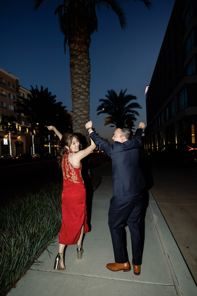 Bride and groom posing outside after their tea ceremony celebration in Los Angeles.