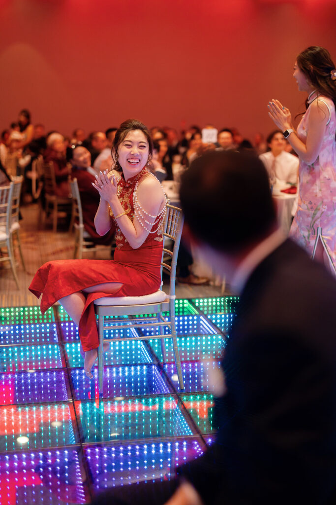 Bride and groom playing a game on the dance floor during their tea ceremony reception in Los Angeles.