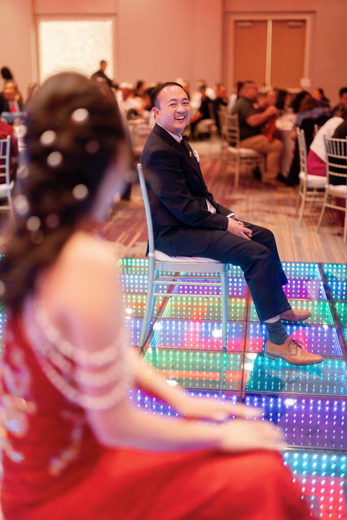 Bride and groom playing a game on the dance floor during their tea ceremony reception in Los Angeles.