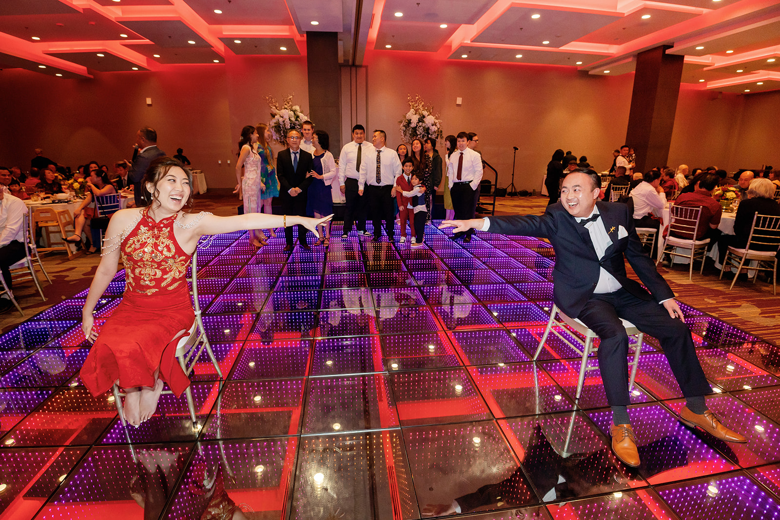 Bride and groom playing a game on the dance floor during their tea ceremony reception in Los Angeles.