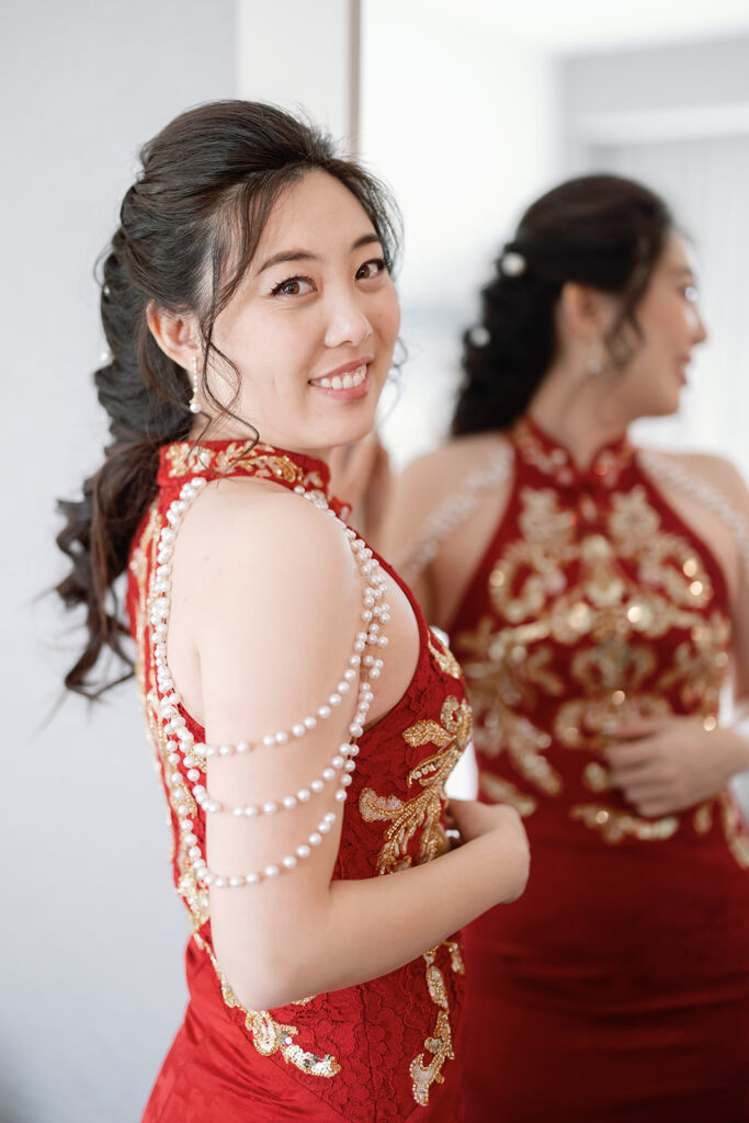 Bride wearing a red traditional tea ceremony dress during a multiday wedding celebration in Los Angeles.