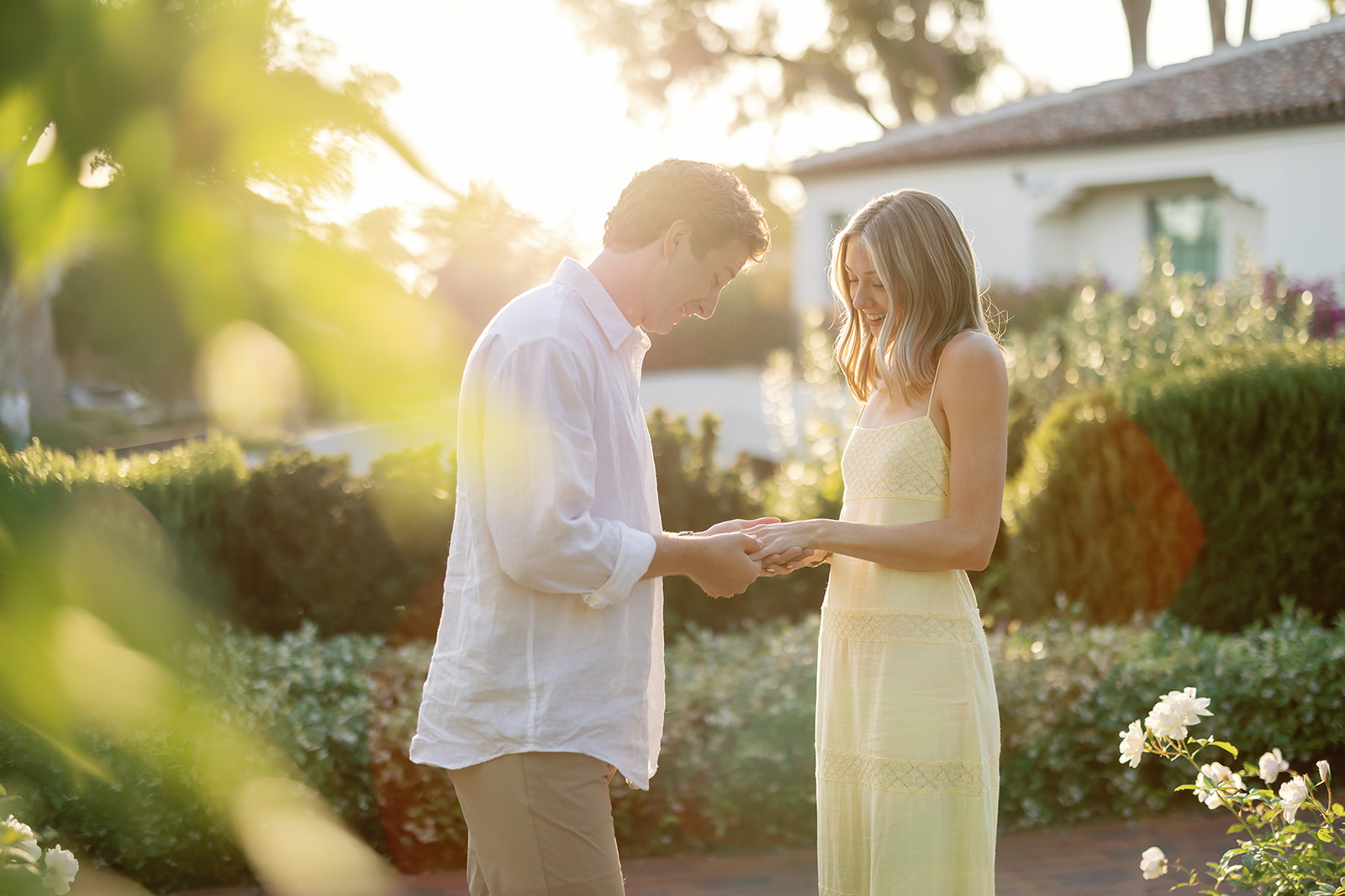 Couple admiring the woman's new engagement ring after their Santa Barbara proposal at El Encanto.