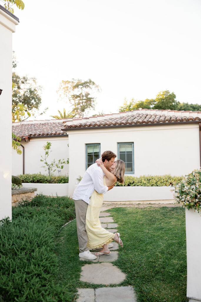Couple kissing along a garden pathway at El Encanto after their Santa Barbara proposal.