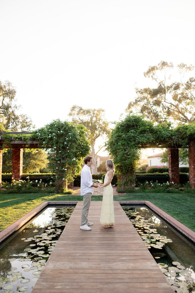 Couple standing on the bridge at the Arbor Lilly Pond at El Encanto in Santa Barbara.