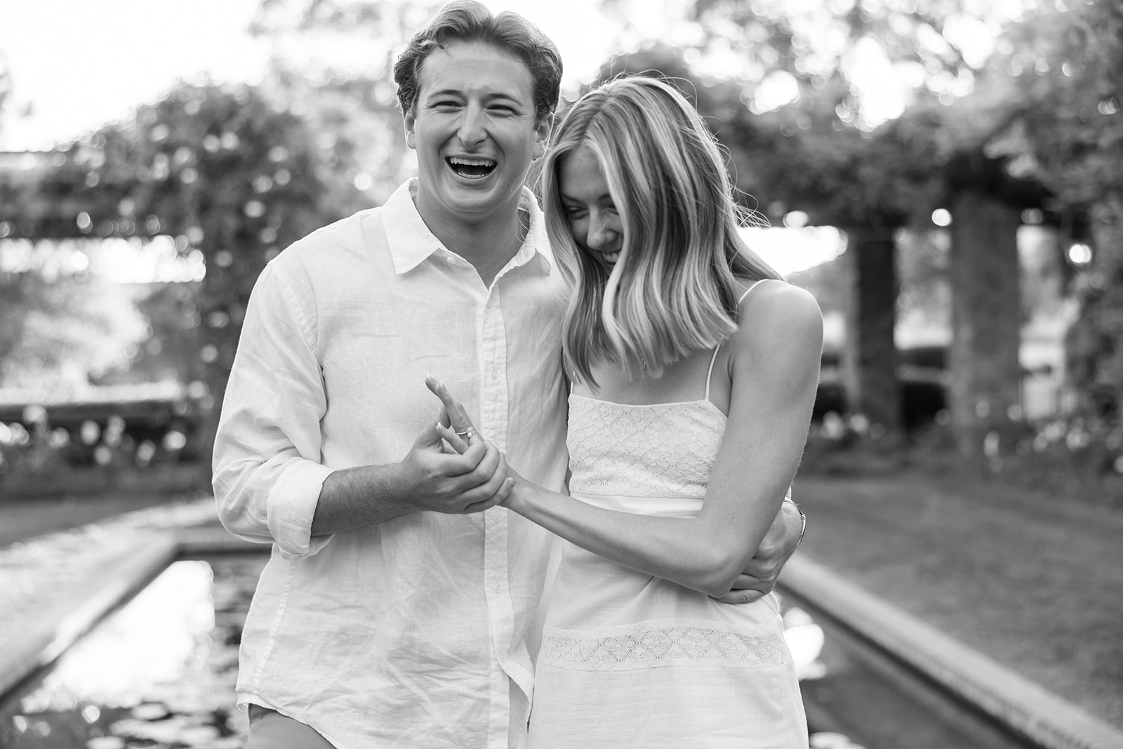 Candid black and white engagement photo of a couple laughing together at El Encanto in Santa Barbara.