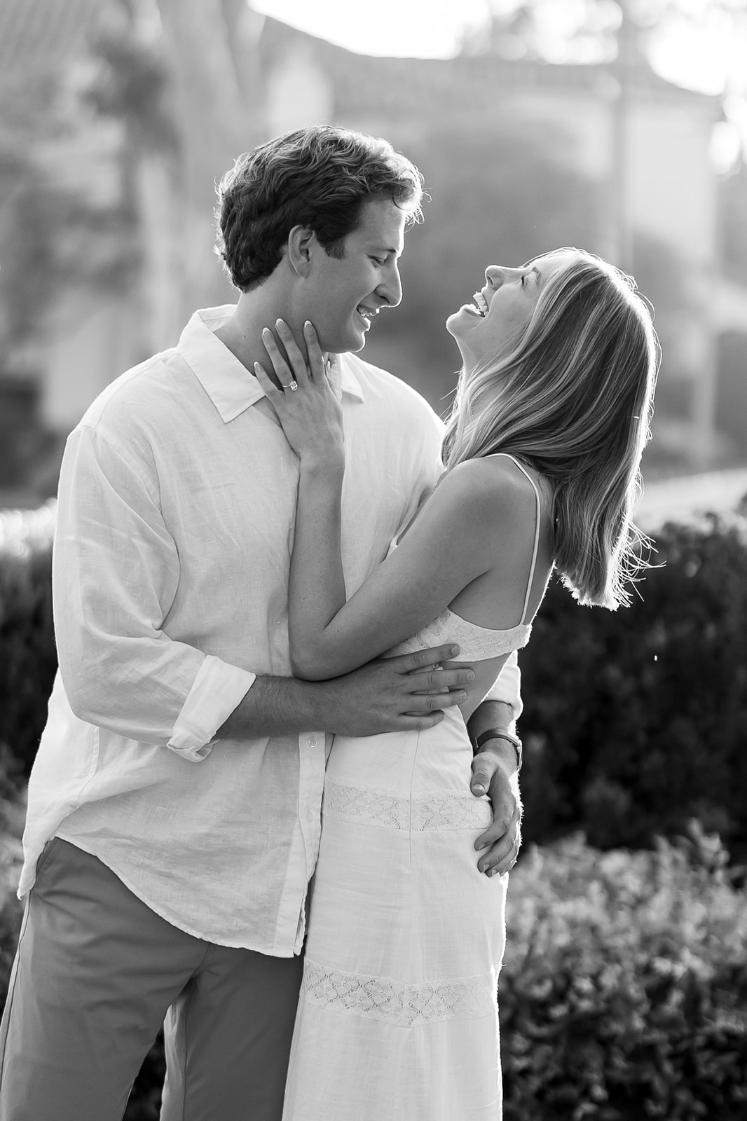 Candid black and white photo of a couple laughing together at El Encanto.