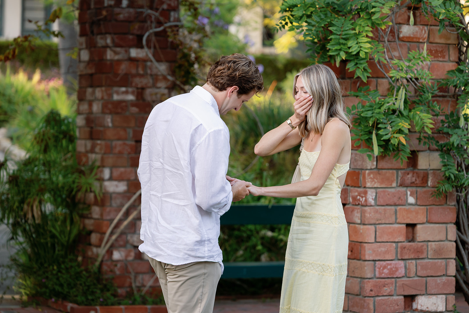Couple sharing an emotional moment after a surprise proposal at El Encanto in Santa Barbara.
