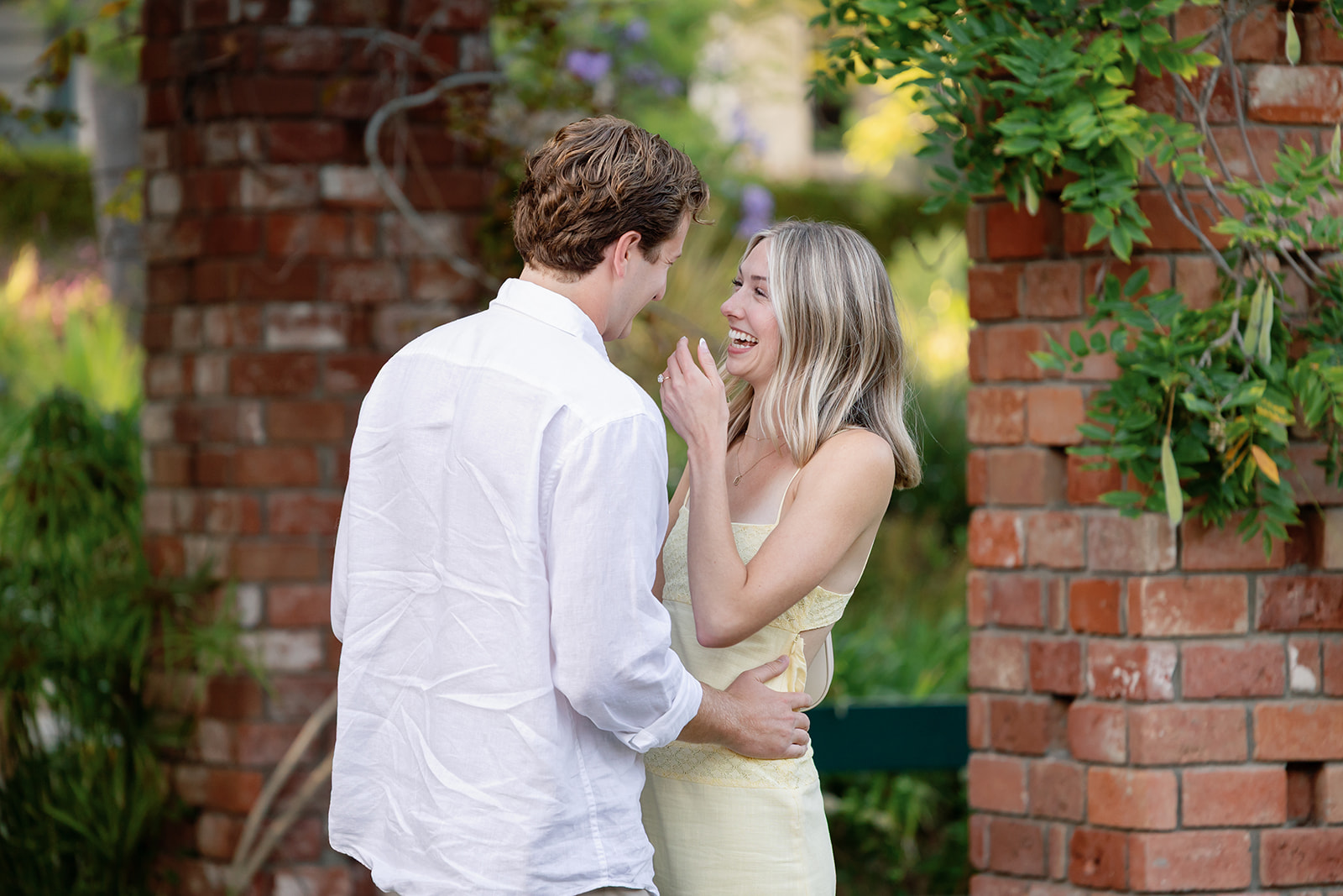 Couple sharing an emotional moment after a surprise proposal at El Encanto in Santa Barbara.