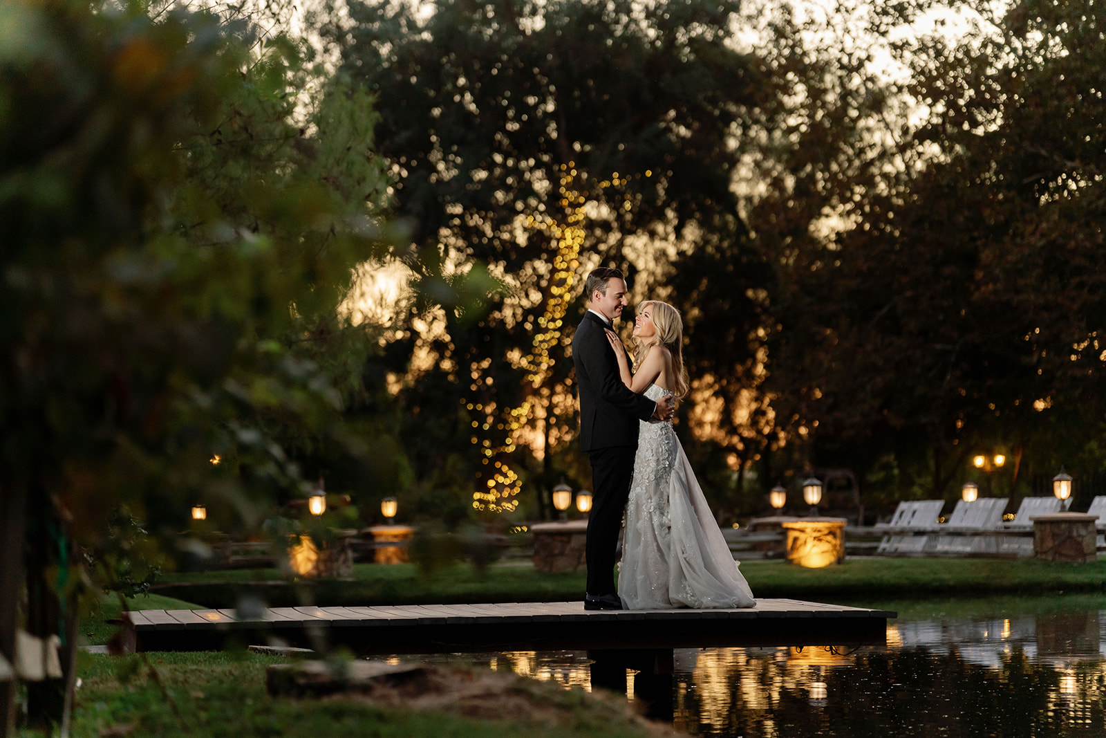 Bride and groom posing on the dock at sunset at Lake Oak Meadows in Temecula.