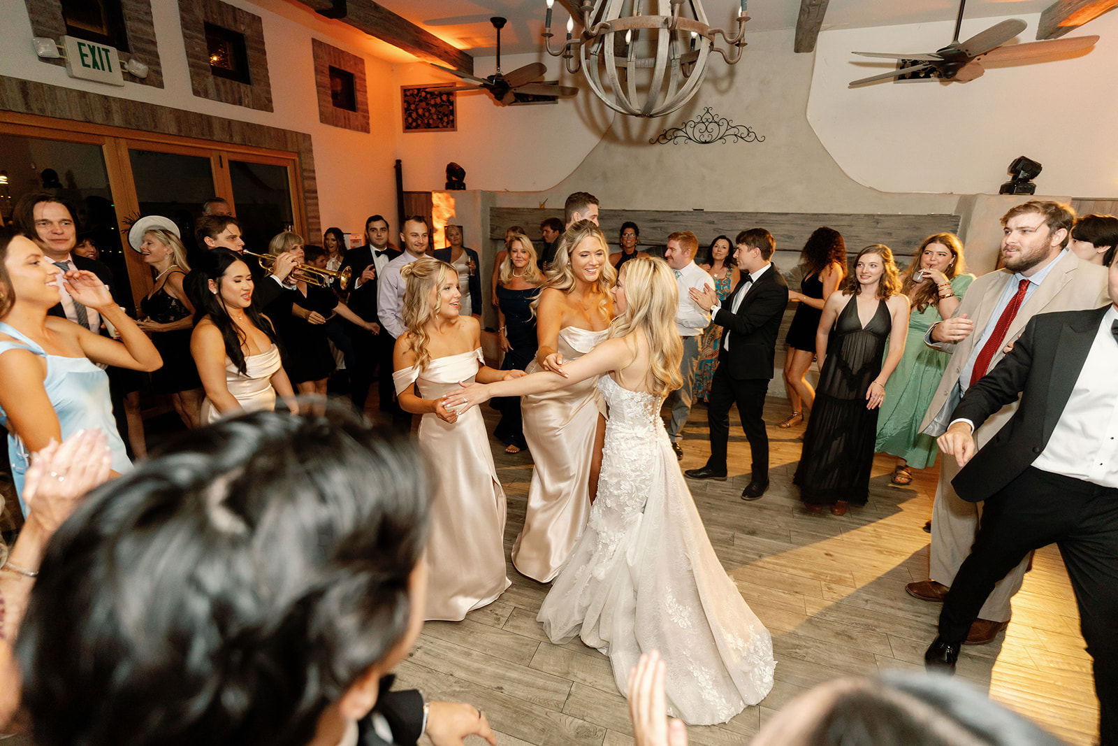Bride dancing with bridesmaids and guests during the indoor reception at Lake Oak Meadows.