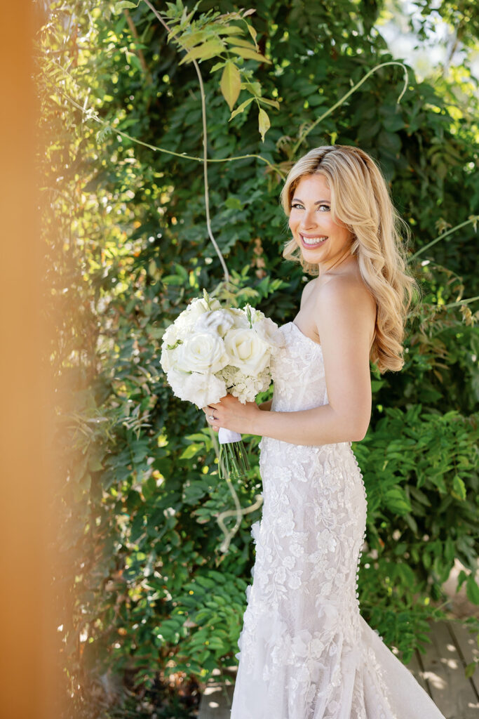 Bride holding a white bouquet for outdoor bridal portraits at Lake Oak Meadows in Temecula California.