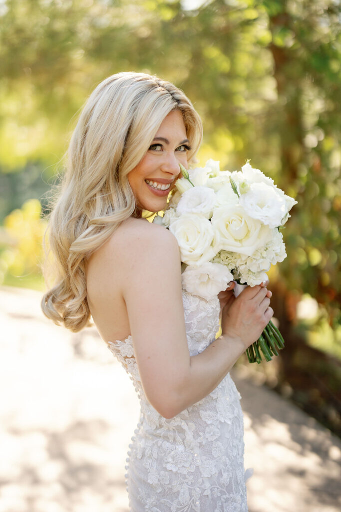Bride holding a white bouquet for outdoor bridal portraits at Lake Oak Meadows in Temecula California.