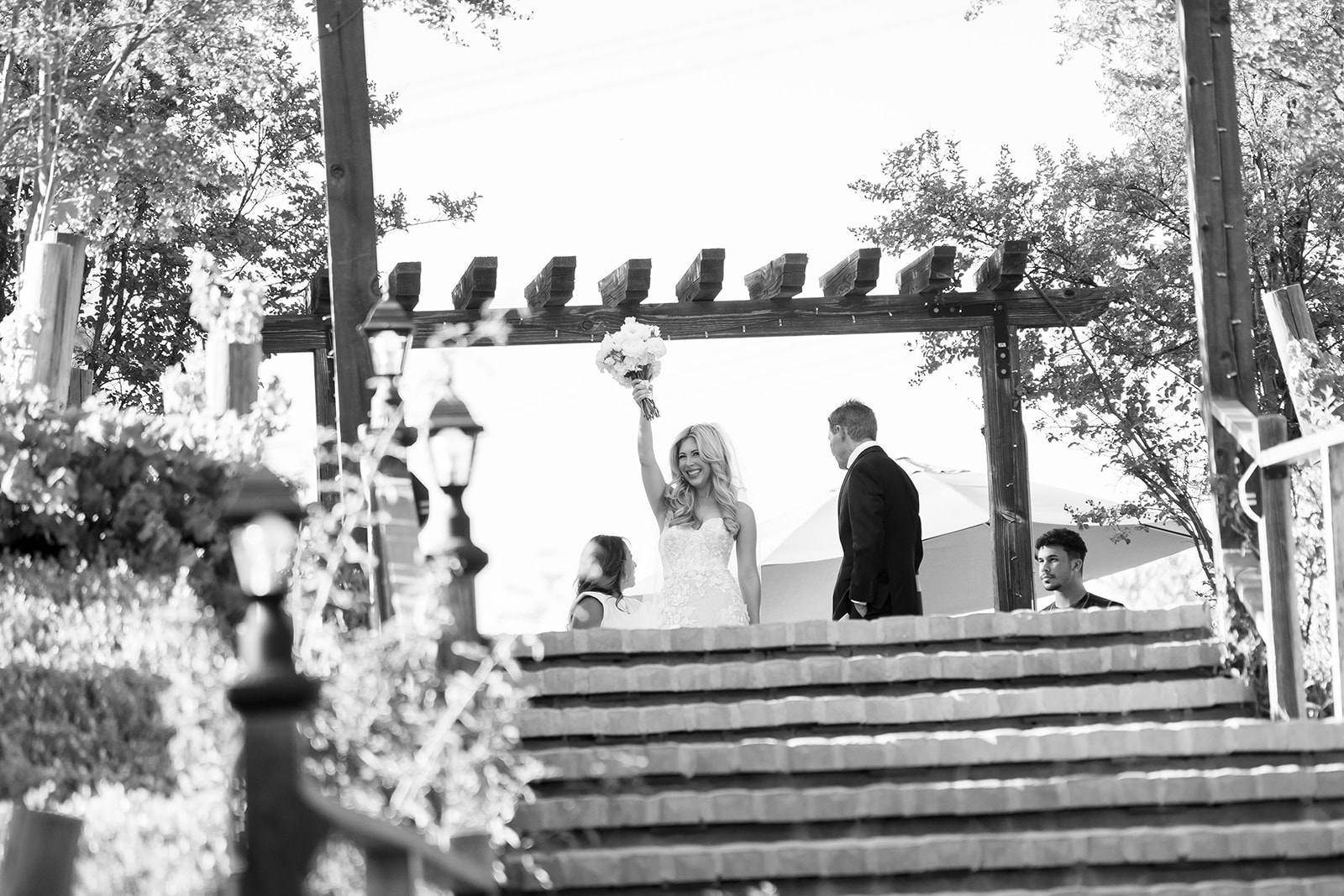 Bride as she's about to walk down the grand staircase with her bouquet before a Lake Oak Meadows wedding ceremony.